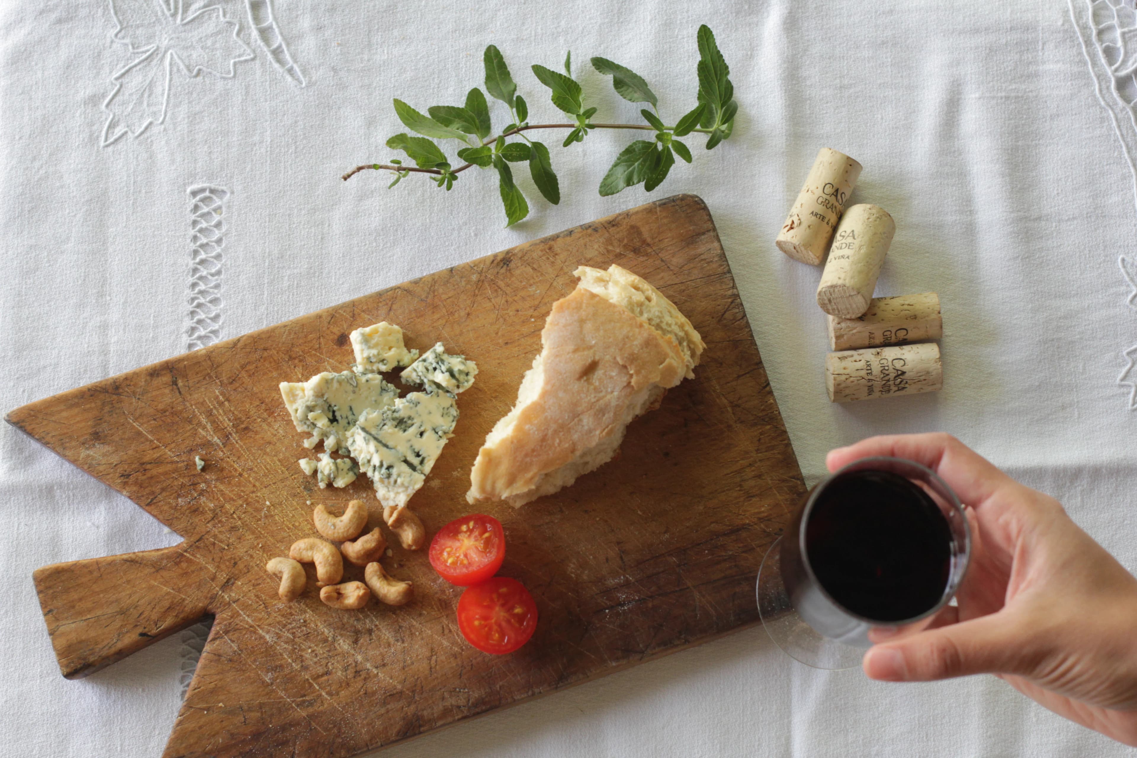 Picada de quesos y frutos secos con vino en copa